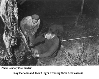 Raty Bebeau and Jack Unger dressing bear